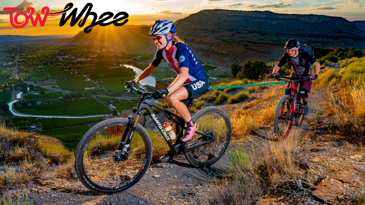 Lady pulling a child up a mountain in Utah using a TowWhee bungee connecting the bikes 