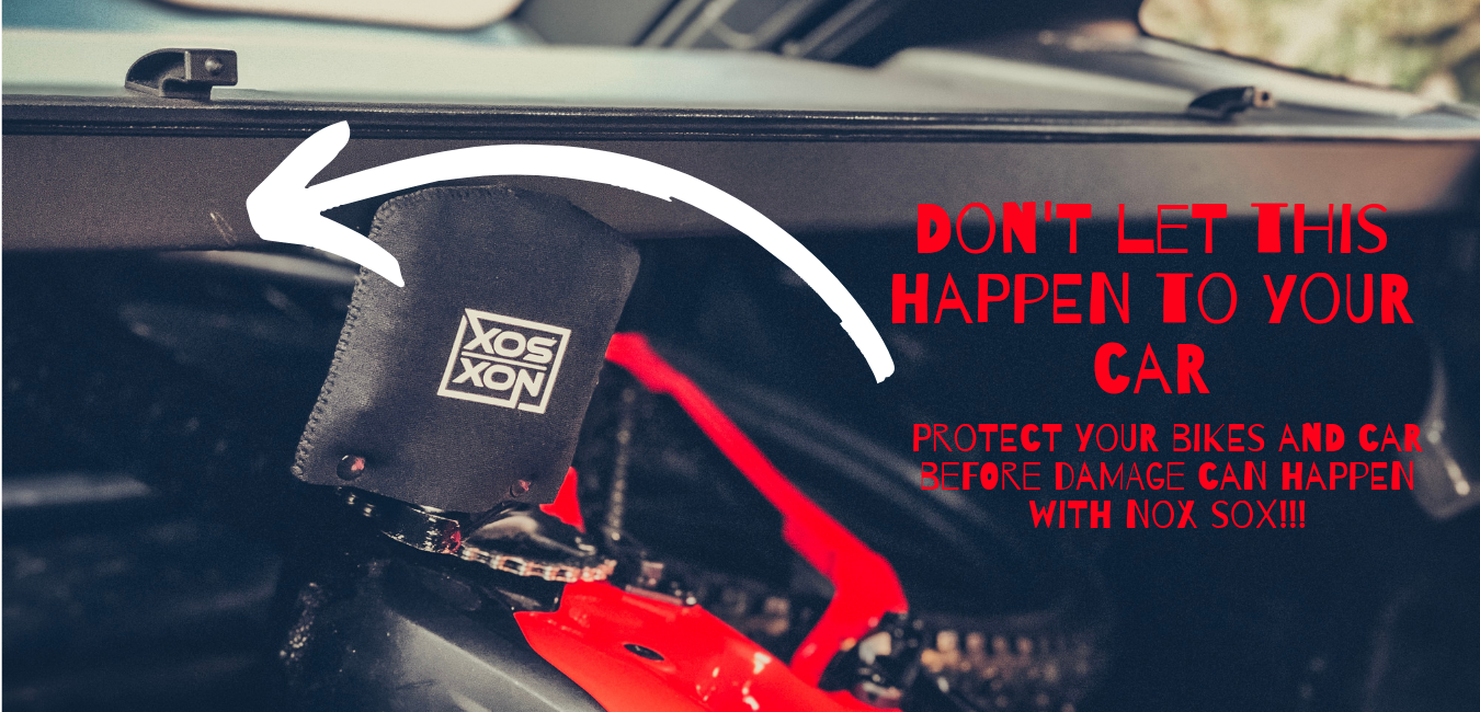 Bike in the boot of a car, there is a scratch where the pedal hit the car before Nox Sox pedal covers were used to prevent further damage